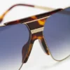 Overdimensjonert metall- og acetatramme i gull-havana