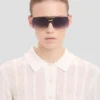 Overdimensjonert metall- og acetatramme i gull-havana